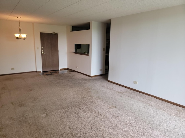 75 Kristin Cir Unit 401, Schaumburg, IL 60195 - unfurnished living room featuring carpet floors, a chandelier, and baseboards