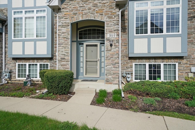 view of exterior entry featuring stone siding