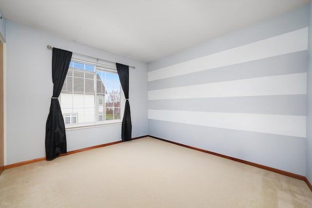 unfurnished room with carpet floors and baseboards