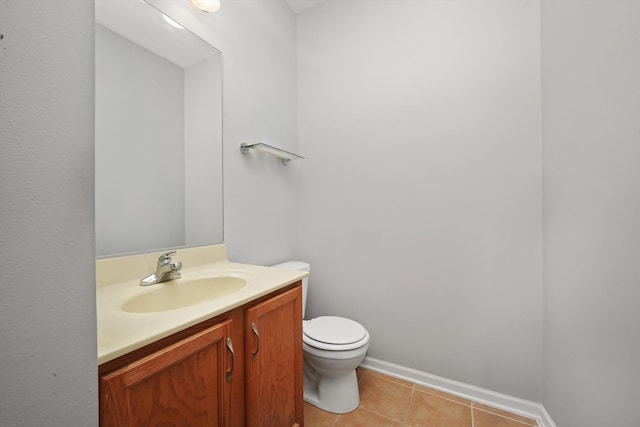 bathroom with vanity, tile patterned flooring, baseboards, and toilet