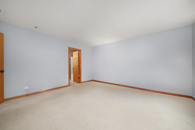 unfurnished room with baseboards and carpet
