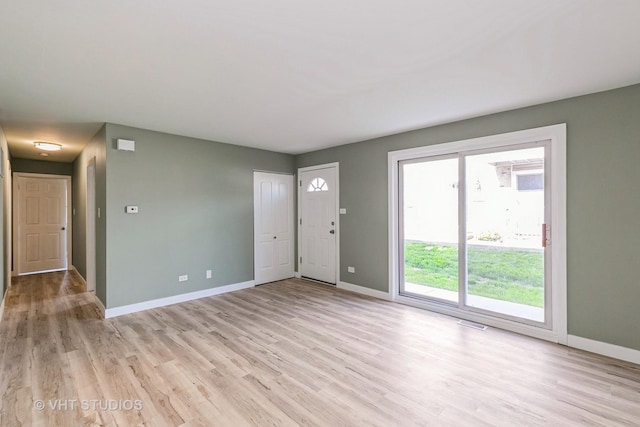 7923 163rd Ct Unit 23, Tinley Park, IL 60477 - unfurnished living room with baseboards and light wood finished floors