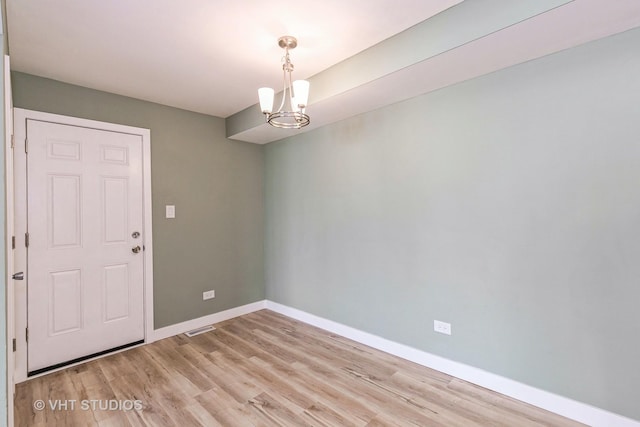 7923 163rd Ct Unit 23, Tinley Park, IL 60477 - empty room featuring a chandelier, light wood finished floors, and baseboards