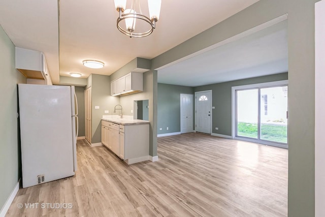7923 163rd Ct Unit 23, Tinley Park, IL 60477 - kitchen with freestanding refrigerator, light wood finished floors, a chandelier, and baseboards