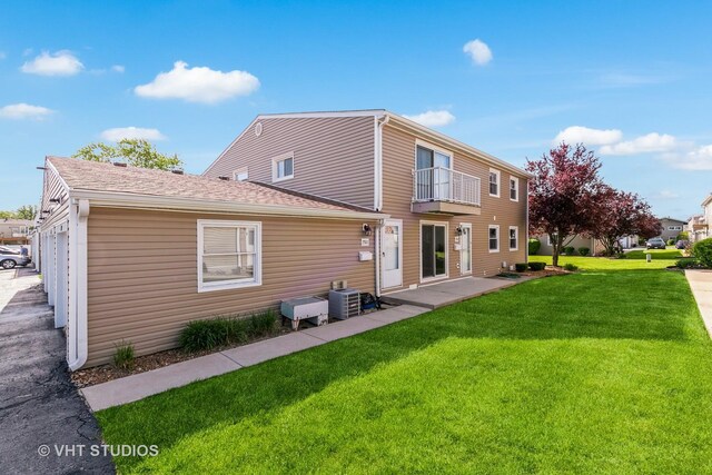 7923 163rd Ct Unit 23, Tinley Park, IL 60477 - back of house with a balcony, a lawn, and cooling unit