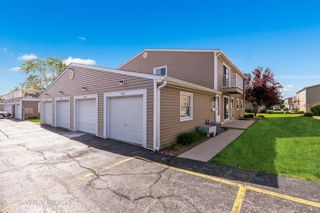 7923 163rd Ct Unit 23, Tinley Park, IL 60477 - view of property exterior with community garages and a yard