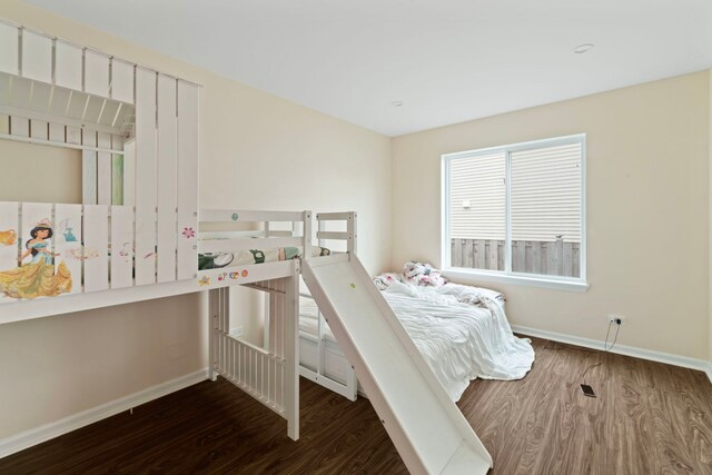 bedroom with baseboards and wood finished floors