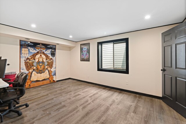 unfurnished office featuring recessed lighting, baseboards, and wood finished floors