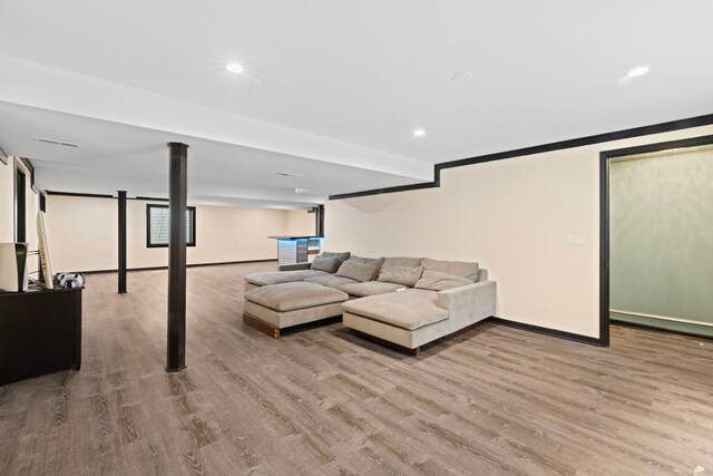 living room with recessed lighting, baseboards, visible vents, and wood finished floors