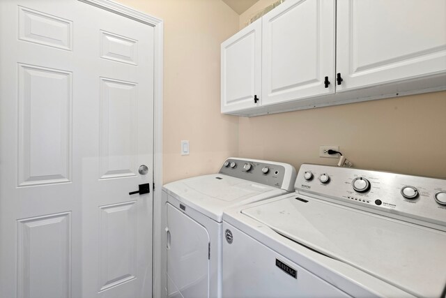 laundry room with cabinet space and washer and dryer