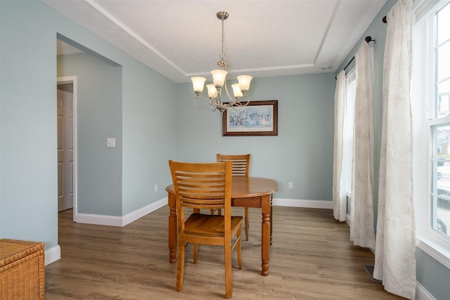 dining room with baseboards, a chandelier, and a wealth of natural light