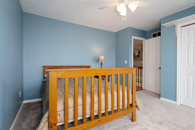 carpeted bedroom featuring a ceiling fan and baseboards