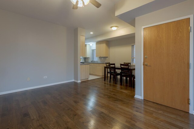 dining area with baseboards, a wealth of natural light, ceiling fan, and dark wood-style flooring