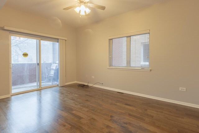 unfurnished living room with baseboards, a ceiling fan, visible vents, and dark wood-type flooring