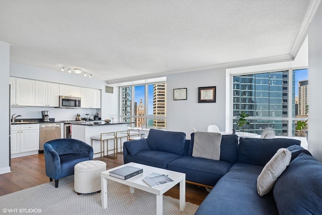 512 N Mcclurg Ct Unit 3304, Chicago, IL 60611 - living area with dark wood-type flooring, a textured ceiling, ornamental molding, and visible vents
