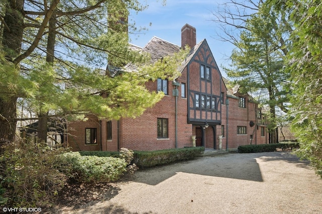 1250 Westmoor Rd, Winnetka, IL 60093 - view of front of house featuring brick siding, a chimney, and a balcony