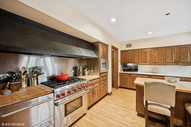 1250 Westmoor Rd, Winnetka, IL 60093 - kitchen featuring appliances with stainless steel finishes, wood counters, light wood finished floors, brown cabinets, and backsplash