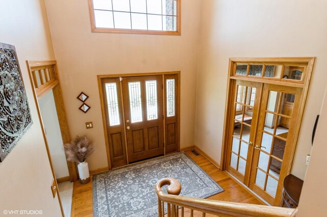 13 W Royal Oaks Dr, Bristol, IL 60512 - entrance foyer with french doors, wood finished floors, a high ceiling, and baseboards