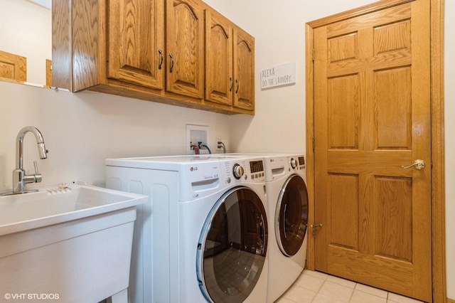 13 W Royal Oaks Dr, Bristol, IL 60512 - washroom featuring washing machine and clothes dryer, cabinet space, and light tile patterned floors