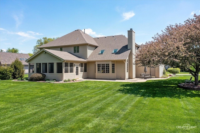 13 W Royal Oaks Dr, Bristol, IL 60512 - back of property featuring a patio, a yard, a chimney, a shingled roof, and a sunroom