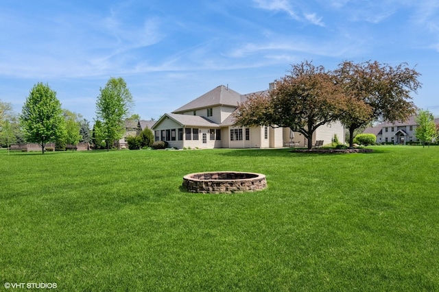 13 W Royal Oaks Dr, Bristol, IL 60512 - view of grassy yard featuring a fire pit and a sunroom