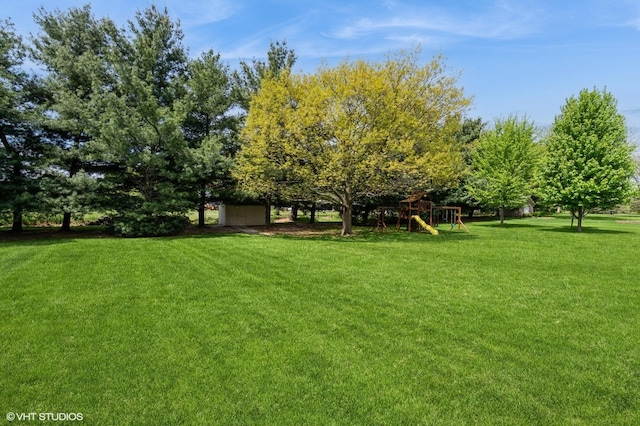 13 W Royal Oaks Dr, Bristol, IL 60512 - view of grassy yard with a playground