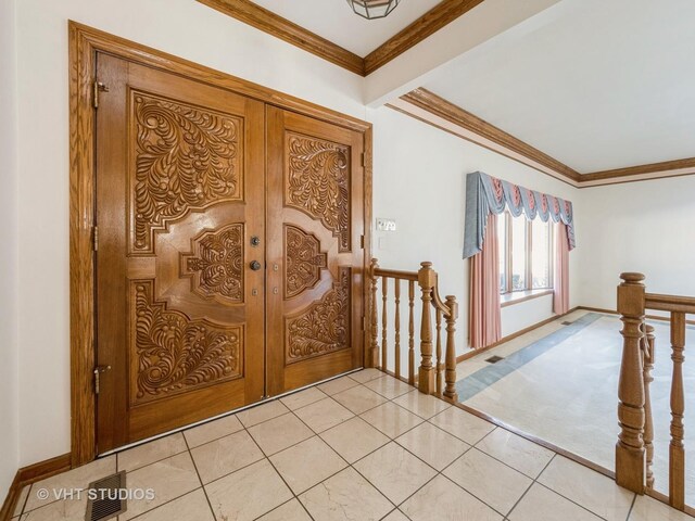 entryway with french doors, baseboards, visible vents, crown molding, and light tile patterned floors
