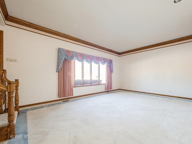 carpeted empty room with stairway, baseboards, and crown molding