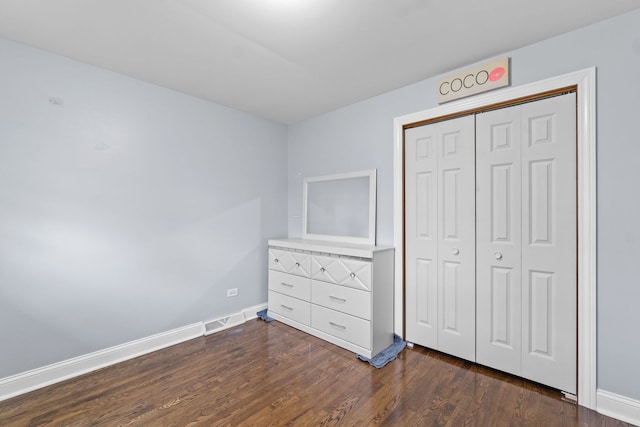 17148 William St, Lansing, IL 60438 - unfurnished bedroom featuring baseboards, visible vents, a closet, and dark wood-type flooring