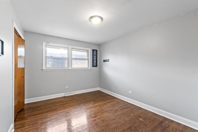 17148 William St, Lansing, IL 60438 - spare room with visible vents, dark wood-style flooring, and baseboards