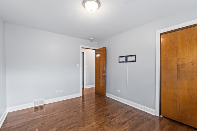 17148 William St, Lansing, IL 60438 - unfurnished bedroom featuring wood finished floors, visible vents, baseboards, and a closet