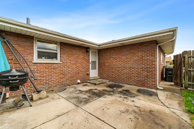 17148 William St, Lansing, IL 60438 - rear view of property with fence, a patio, and brick siding