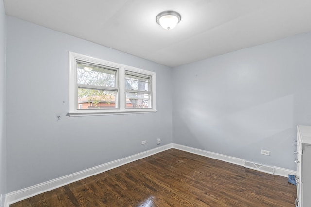 17148 William St, Lansing, IL 60438 - unfurnished room featuring baseboards, visible vents, and dark wood-style flooring
