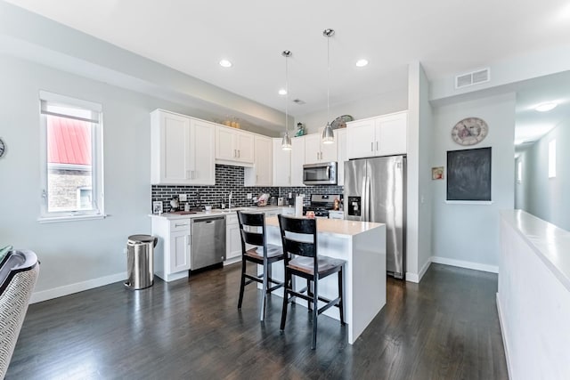 2143 W 19th St Unit 3, Chicago, IL 60608 - kitchen with light countertops, baseboards, stainless steel appliances, and visible vents