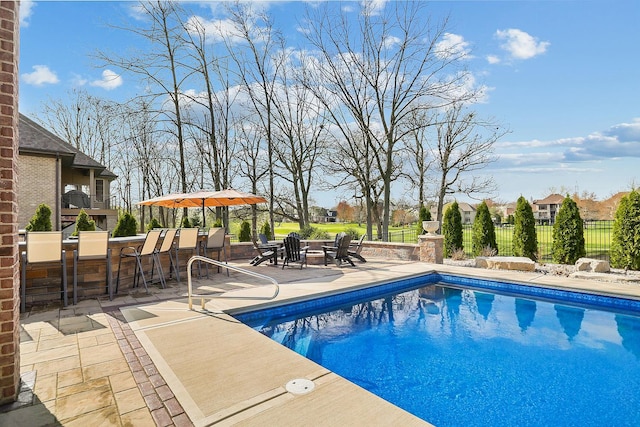 view of pool with a patio area and fence
