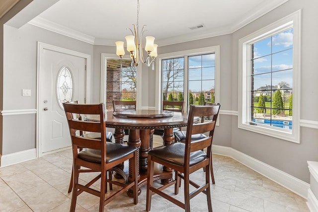 dining space featuring a chandelier, healthy amount of natural light, crown molding, and baseboards