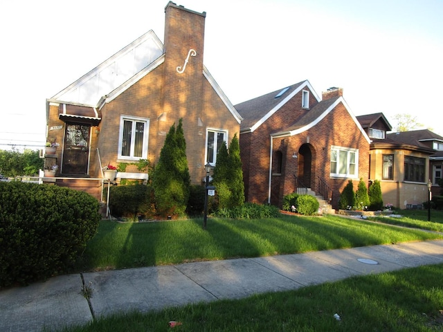9201 S Marshfield Ave, Chicago, IL 60620 - english style home featuring a chimney, brick siding, and a front lawn