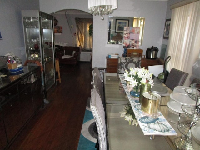 9201 S Marshfield Ave, Chicago, IL 60620 - dining area featuring a chandelier, arched walkways, and wood finished floors