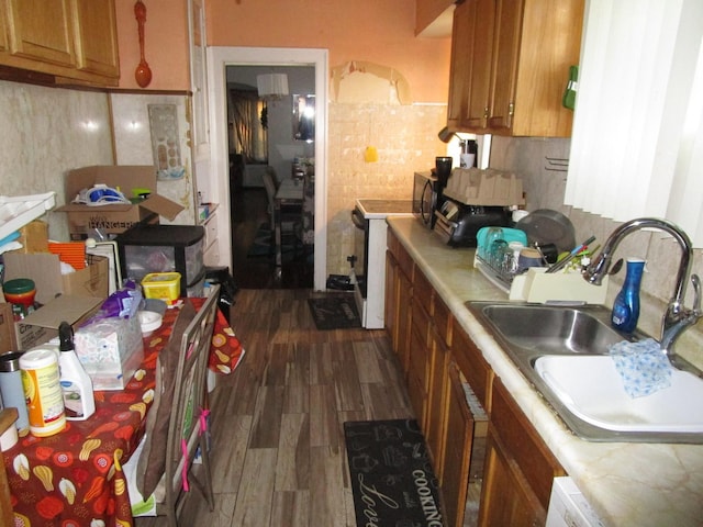 9201 S Marshfield Ave, Chicago, IL 60620 - kitchen with a sink, light countertops, dark wood-type flooring, brown cabinets, and tasteful backsplash