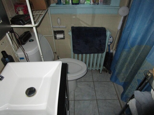 9201 S Marshfield Ave, Chicago, IL 60620 - bathroom featuring a sink, tile walls, tile patterned flooring, and toilet