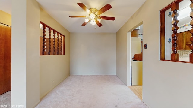 spare room with light carpet and a ceiling fan