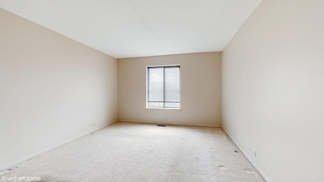 empty room with baseboards and carpet flooring