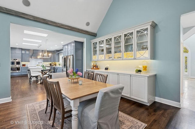 3118 Oliver Ln, Northbrook, IL 60062 - dining room with a skylight, dark wood-style flooring, a chandelier, lofted ceiling, and baseboards