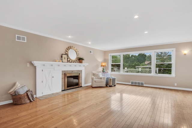 201 Junior Ave, Grayslake, IL 60030 - living area featuring a fireplace, light wood-style floors, ornamental molding, baseboards, and recessed lighting