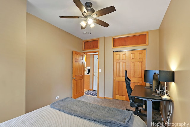 bedroom featuring baseboards, ceiling fan, carpet floors, and a closet