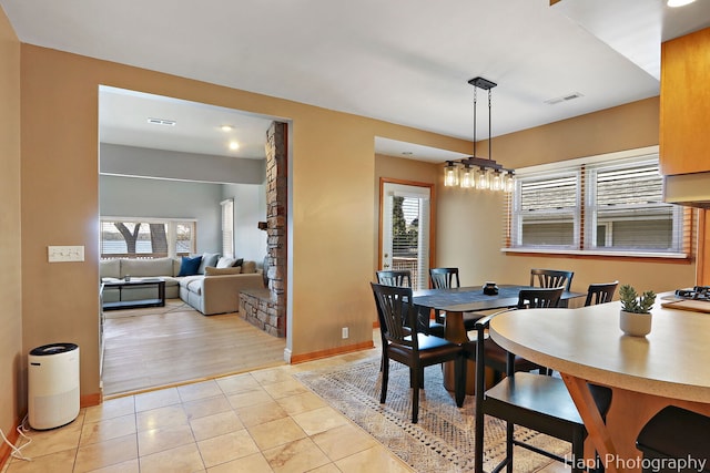dining room featuring visible vents, light tile patterned floors, and plenty of natural light