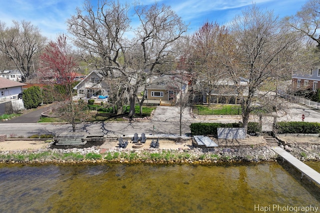 view of dock with a water view and a residential view