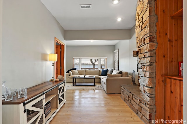 living room featuring visible vents, recessed lighting, and light wood finished floors