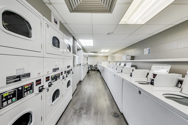 1560 N Sandburg Ter Unit 2301J, Chicago, IL 60610 - shared laundry area with stacked washer and dryer, light wood-style floors, separate washer and dryer, and visible vents