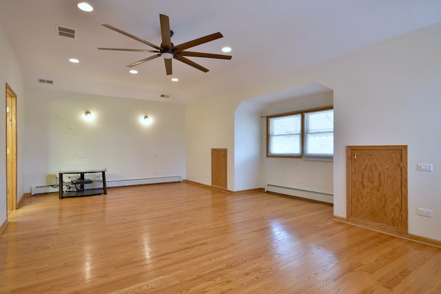 empty room with light wood-type flooring, ceiling fan, visible vents, and a baseboard radiator